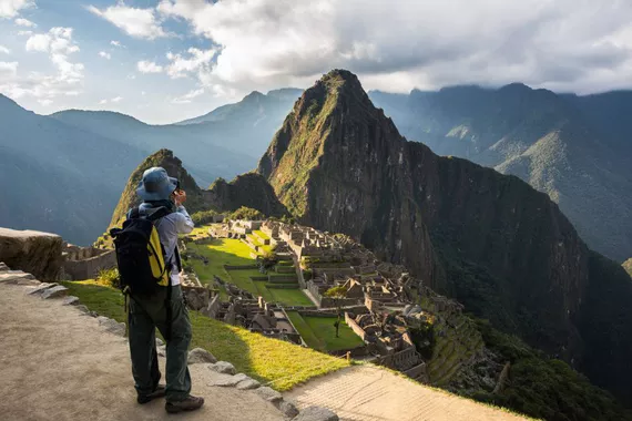 Homem fotografando paisagem em Machu Picchu, no Peru